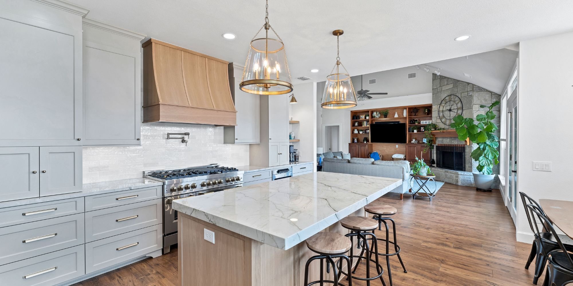 Open-concept kitchen renovation in San Antonio with shaker cabinets and large center island by Hill Haven Homes
