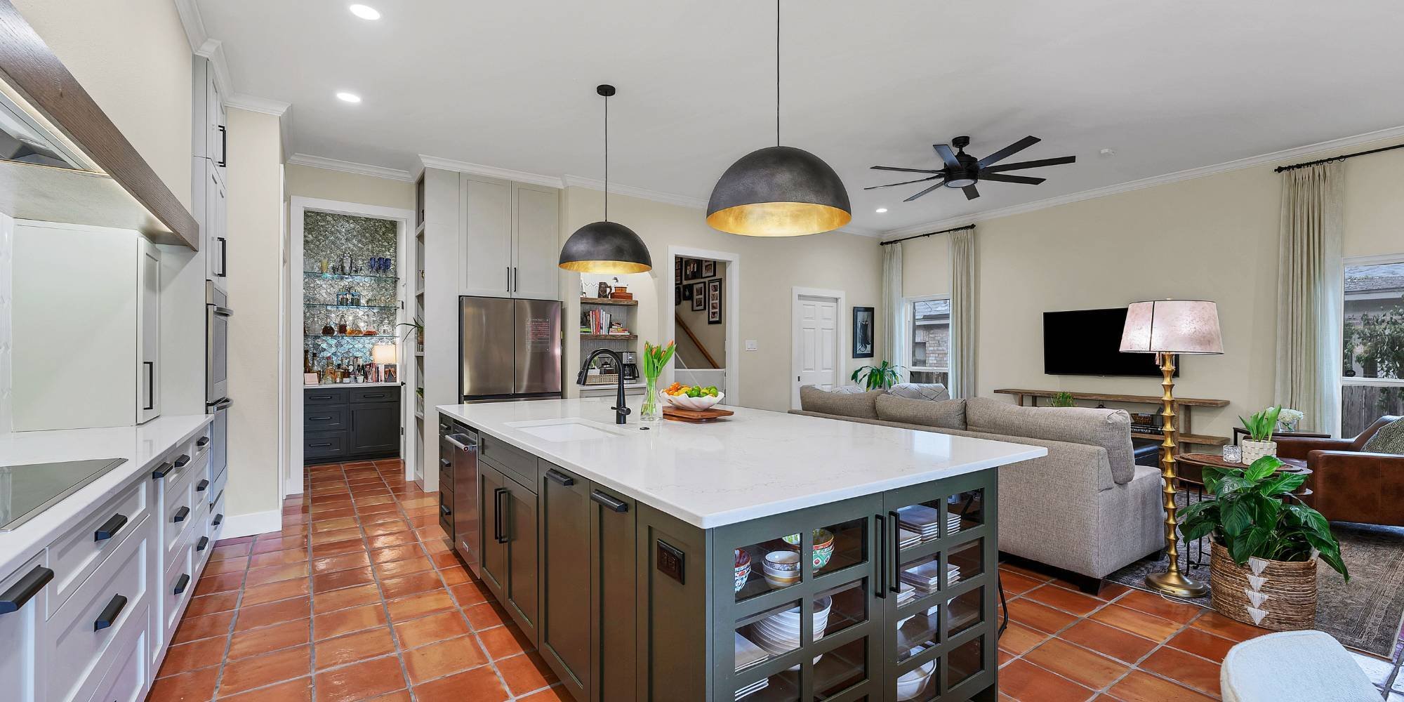 Modern San Antonio kitchen remodel featuring open layout, white cabinets, and sleek black fixtures