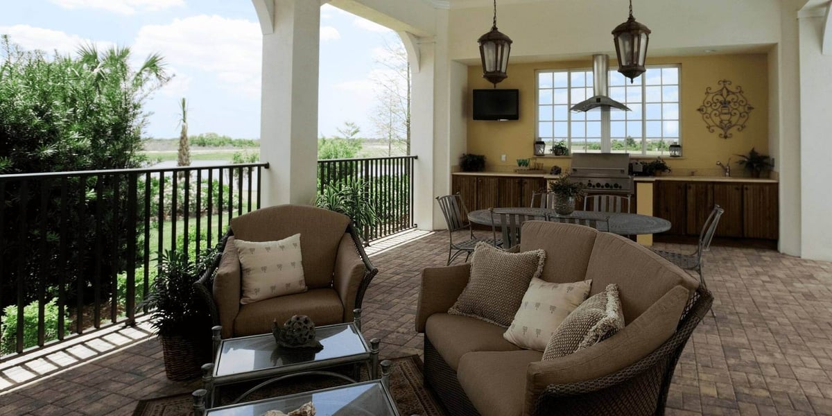 Outdoor living space with covered patio and kitchen by Hill Haven Homes