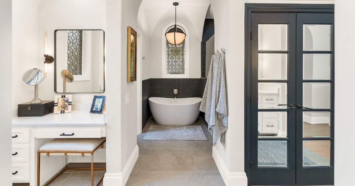 Elegant custom bathroom in San Antonio with arched ceilings, soaking tub, and vanity, designed by Hill Haven Homes