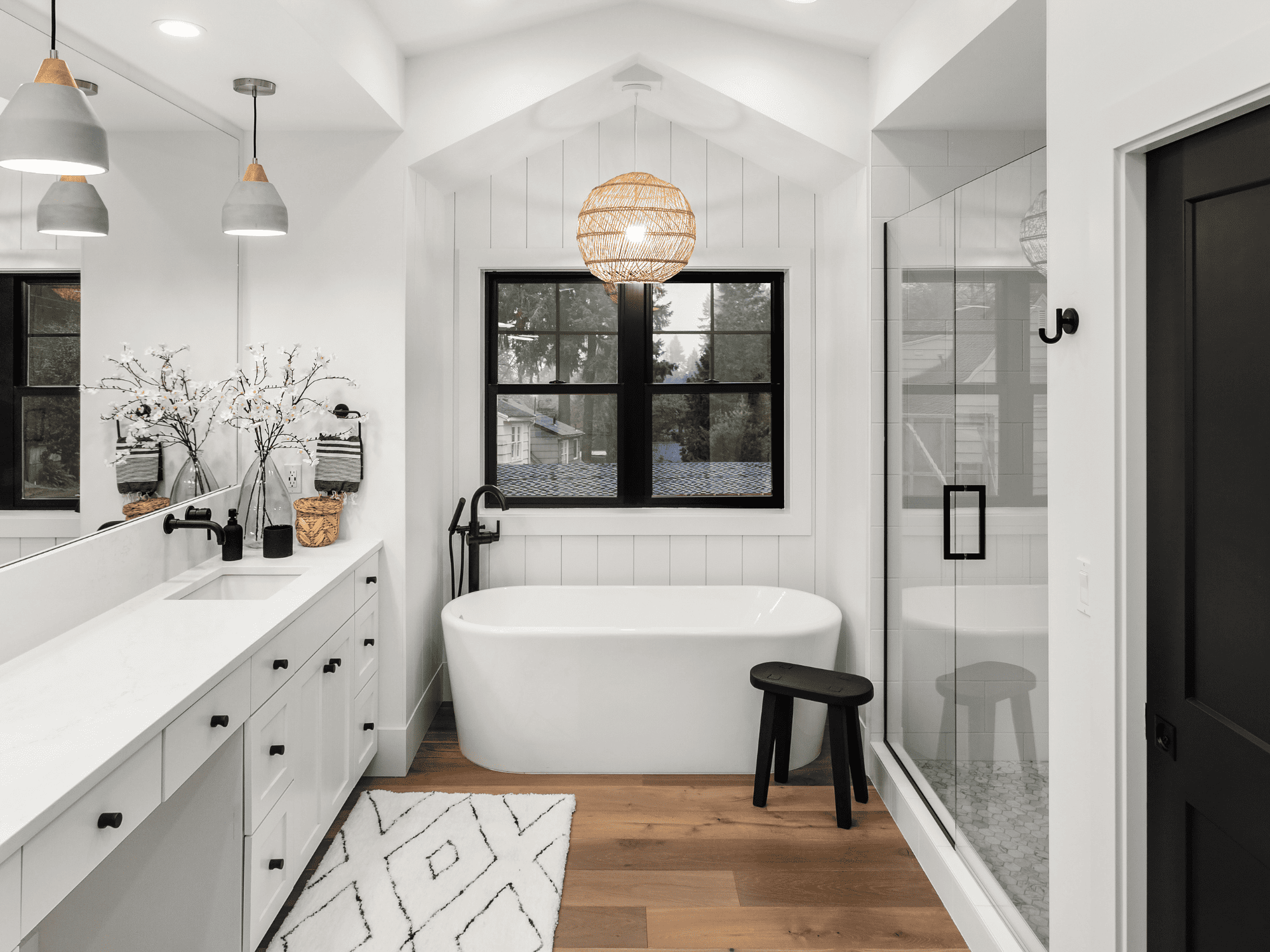 Remodeled Bathroom in River Crossing white walls with black accents