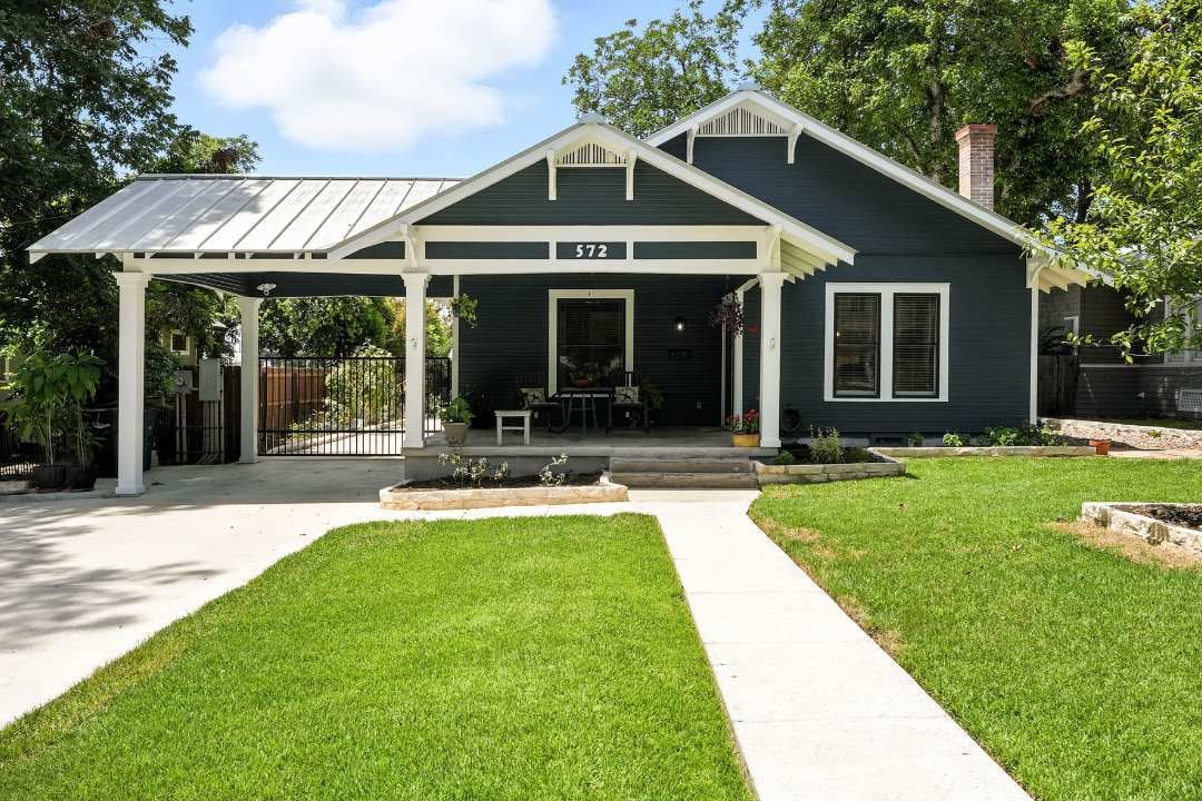 Front view of a craftsman-style home with covered porch and driveway, renovated by Hill Haven Homes in San Antonio