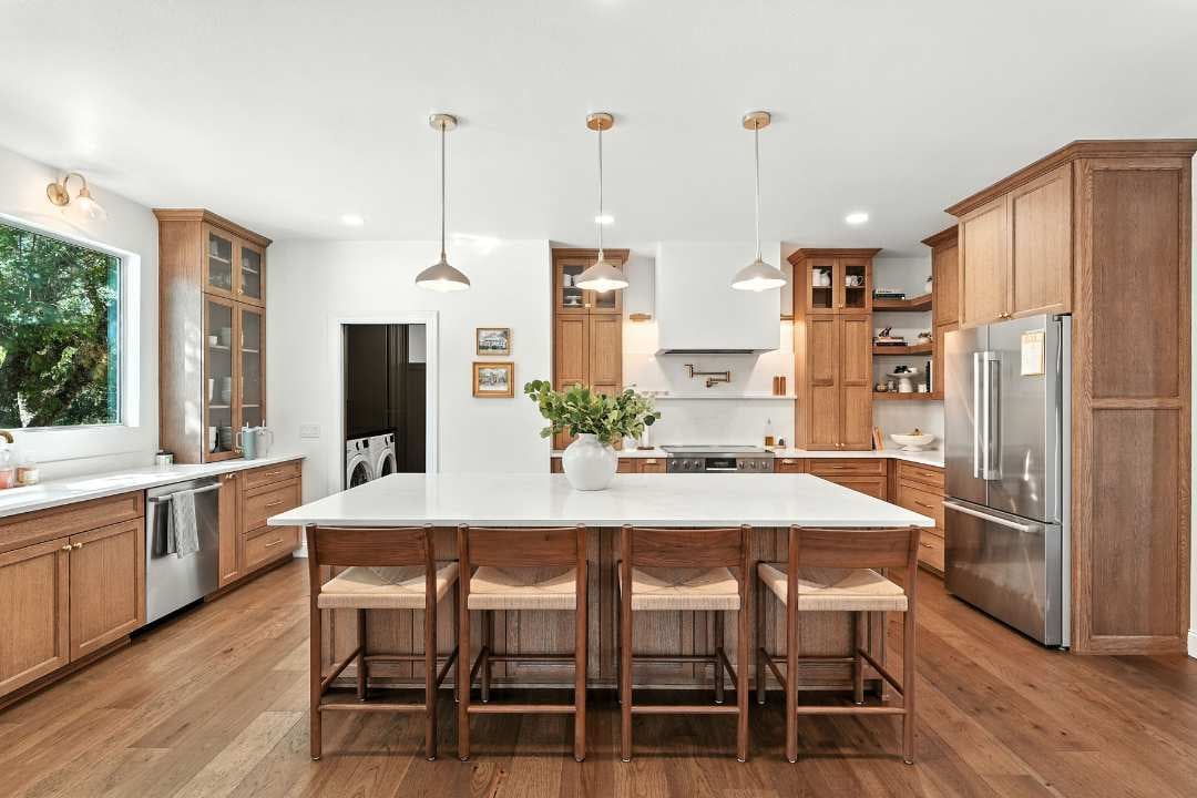 Kitchen remodel with wood cabinetry, large island, and pendant lighting by Hill Haven Homes in San Antonio