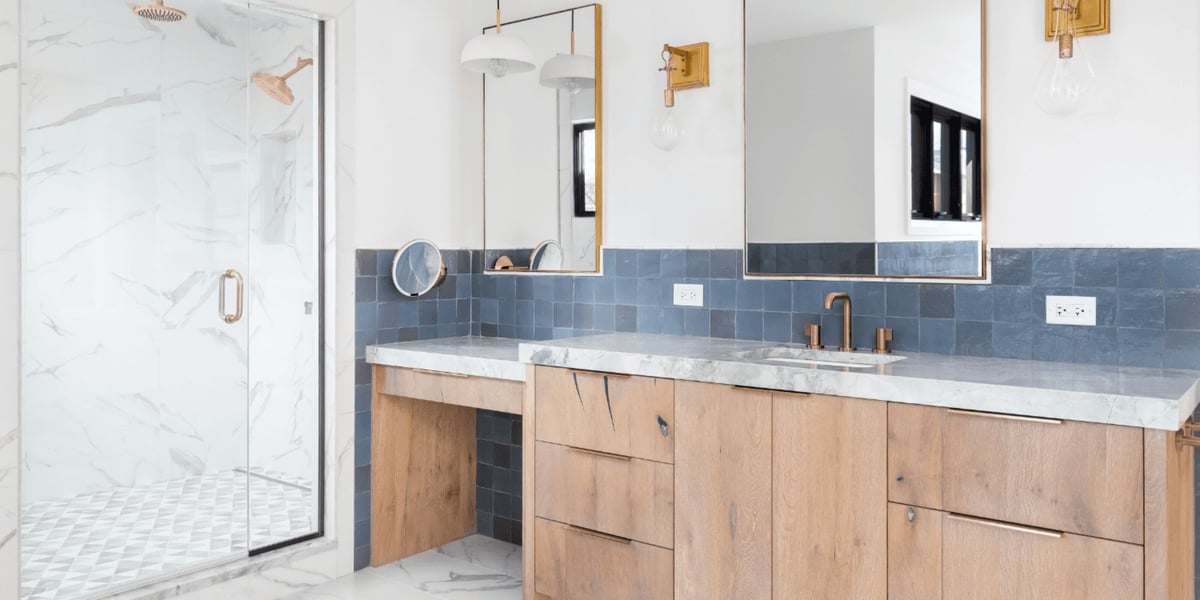 Luxurious bathroom remodel in San Antonio by Hill Haven Homes with marble and wood finishes
