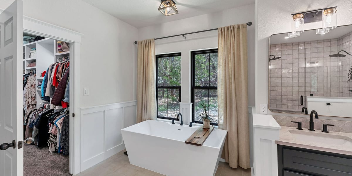 Modern San Antonio bathroom renovation by Hill Haven Homes featuring black fixtures and tile shower