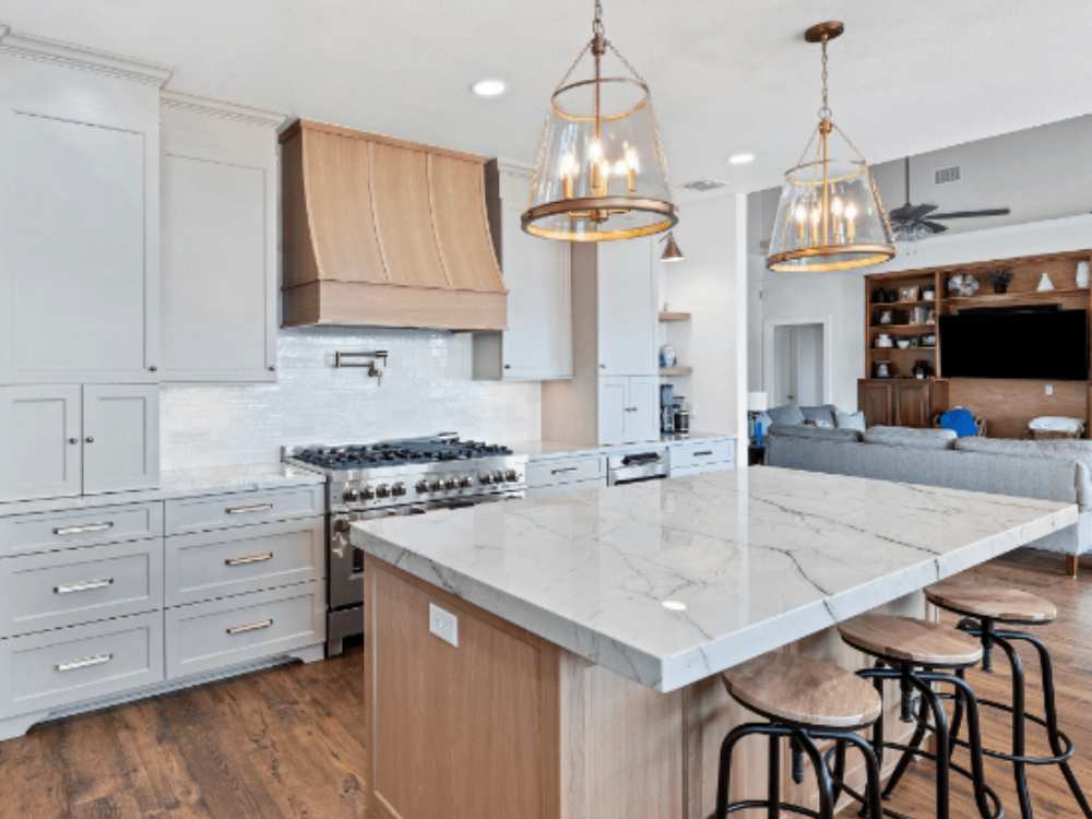 Spacious kitchen remodel featuring light gray cabinets in River Crossing by Hill Haven Home-1