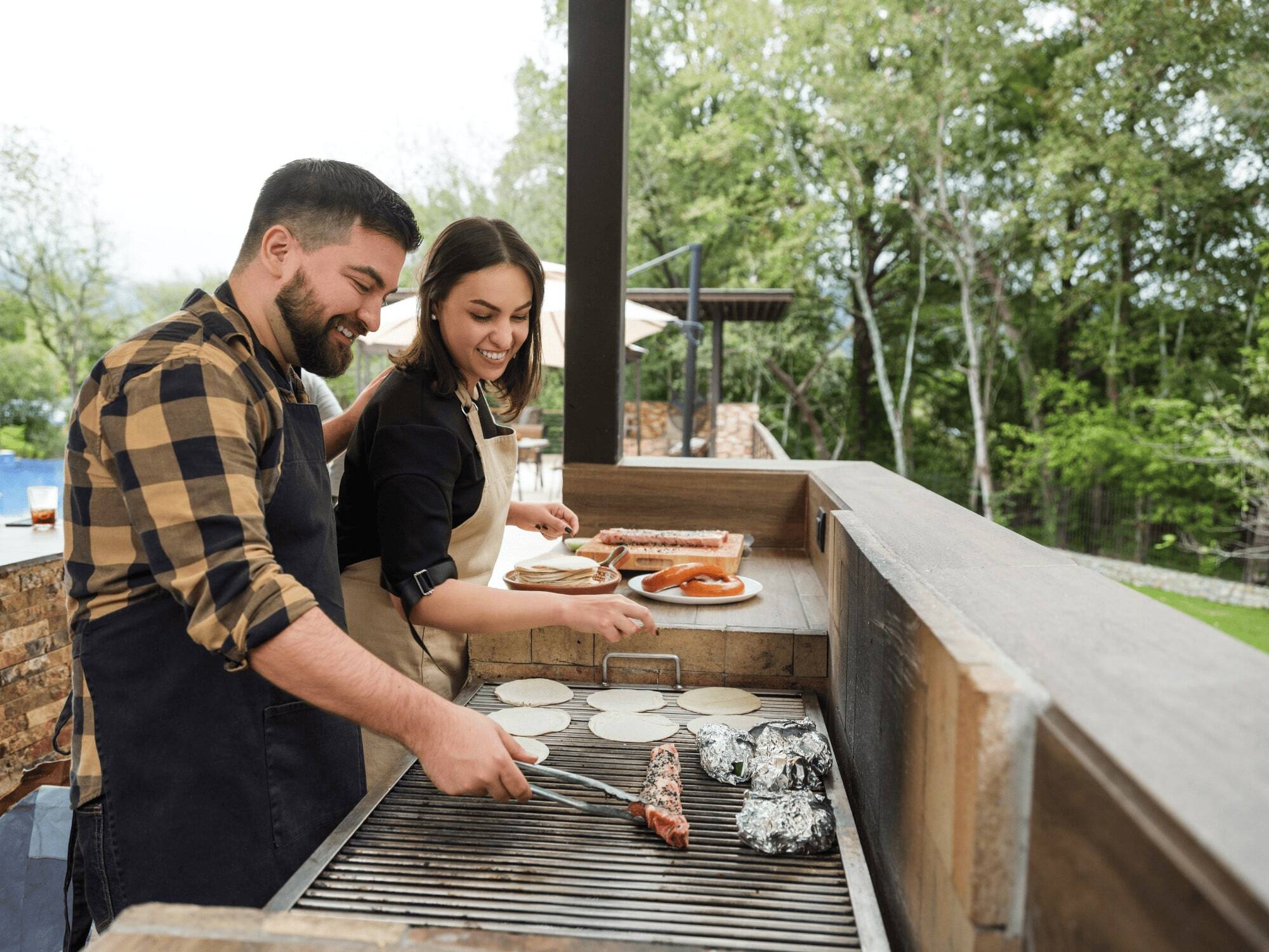 People Cooking in a Custom Outdoor Kitchen