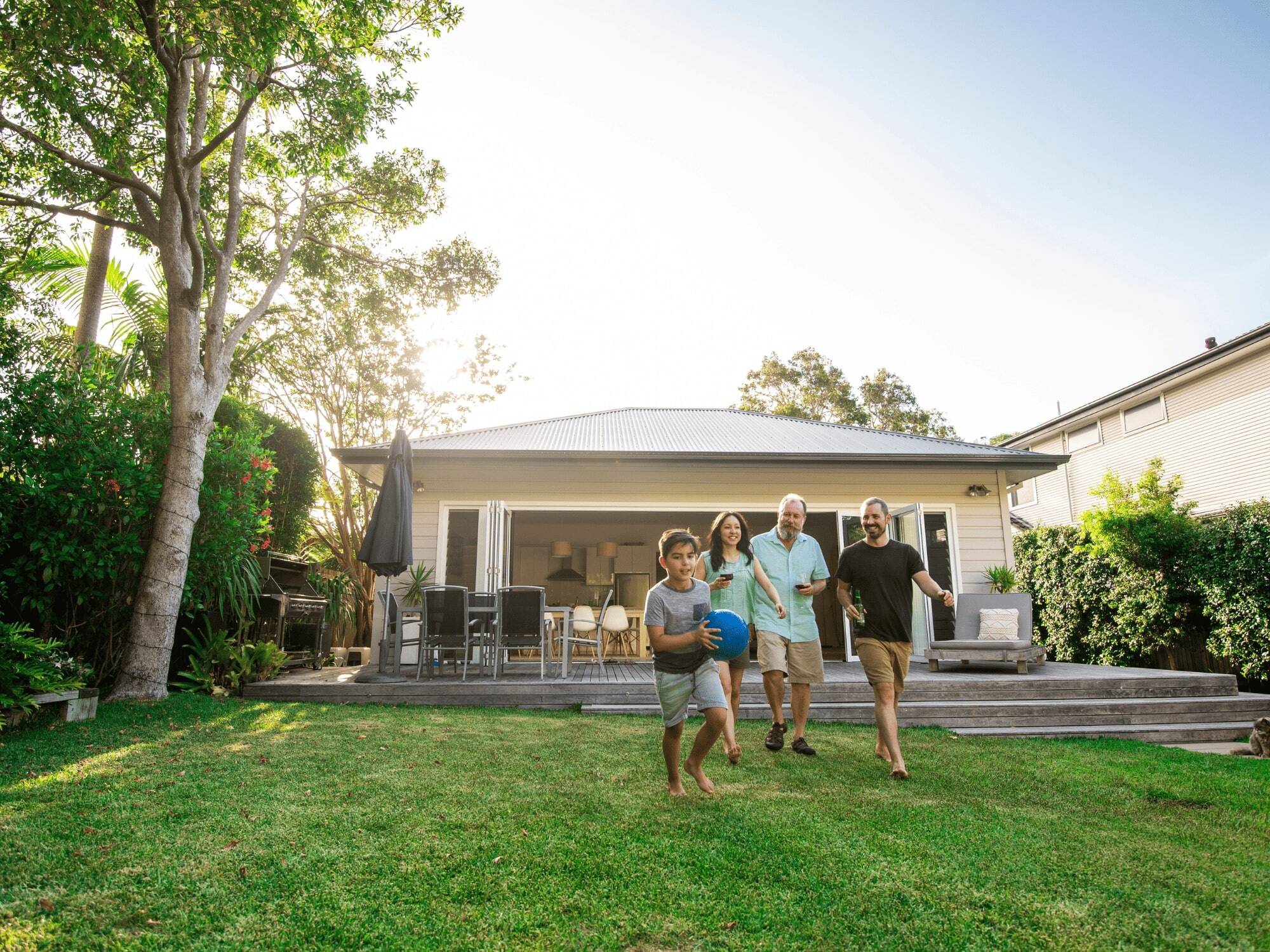 Family in Yard with Outdoor Kitchen